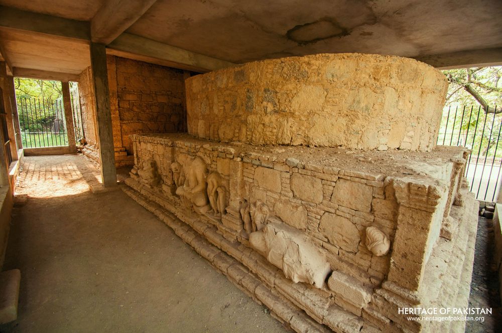 Relief carvings line the stupa base within Mohra Moradu's covered chamber.